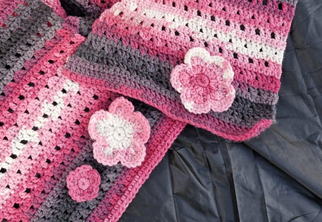 Close-up of the three crochet flowers on the Batik Flower Shawl