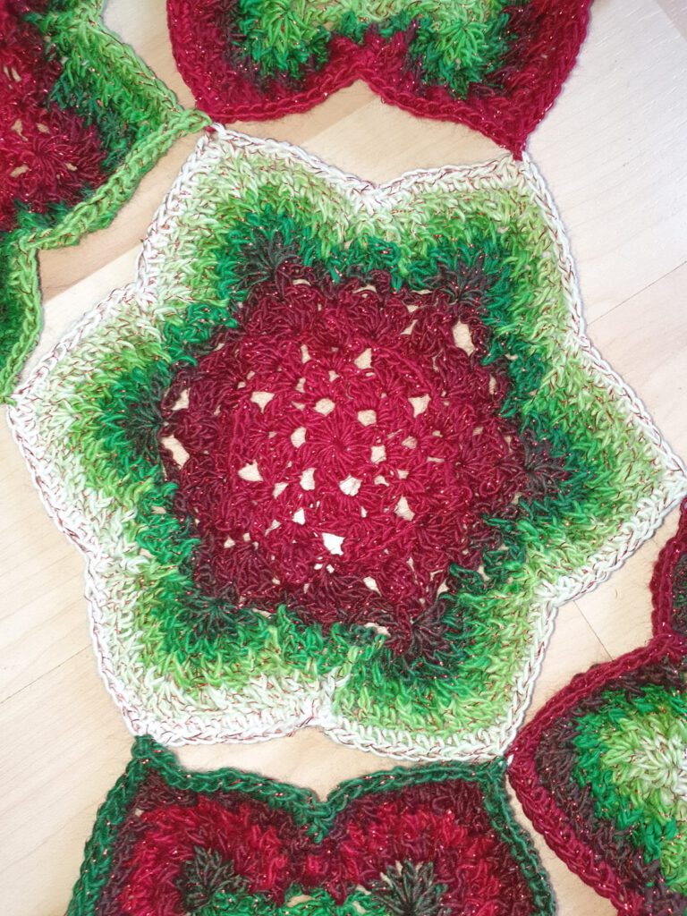 Close-up of a crochet hexie star with popcorn stitches and front post stitches