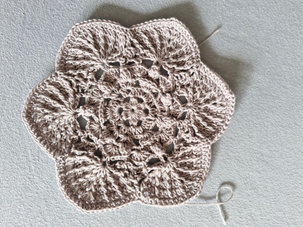 Grey crochet hexie star in Scheepjes Whirlette before blocking